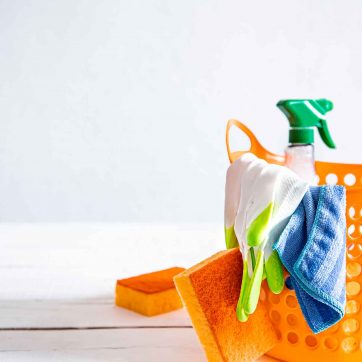 Close up set of home cleaning products in a bright basket. Means for maintaining cleanliness.